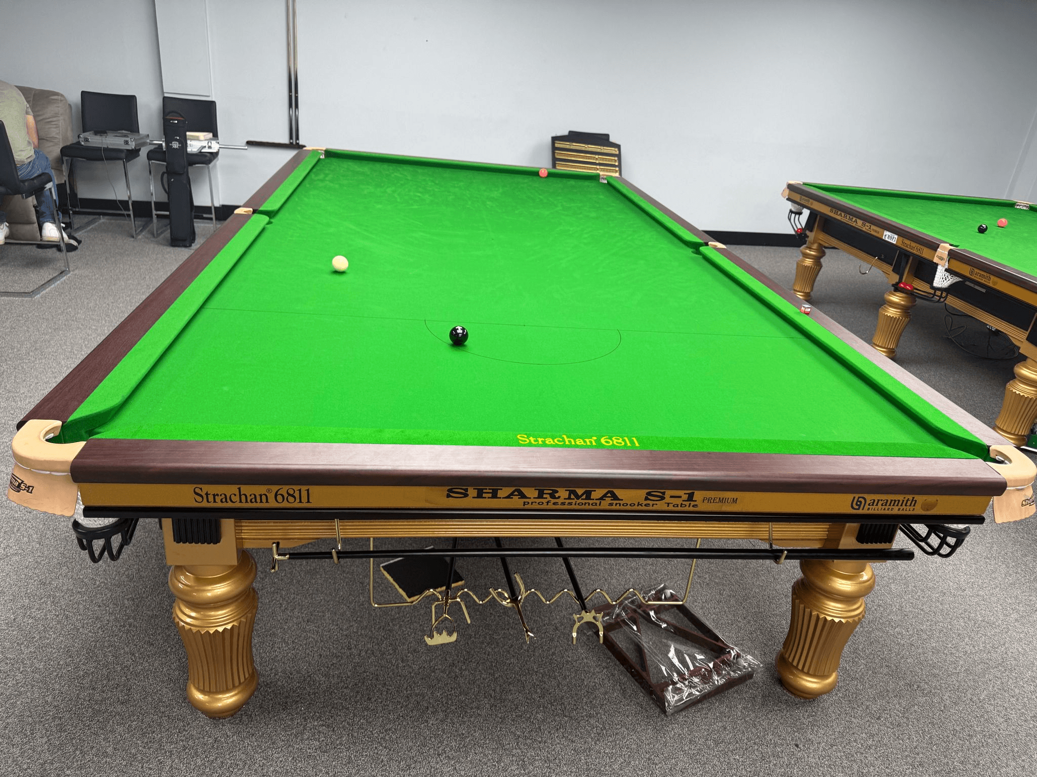 Tournament-style cloth, lighting, and table proportions.